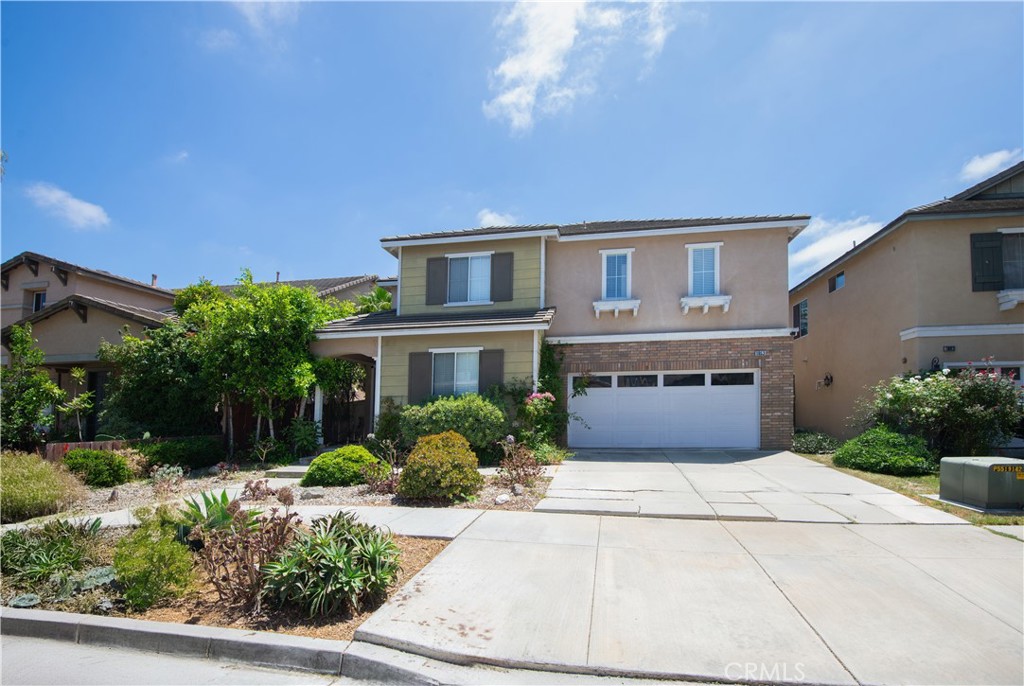 1652 Tiesa Lane Oxnard, CA 93030 - Photo 2 of 9 a front view of a house with a garden