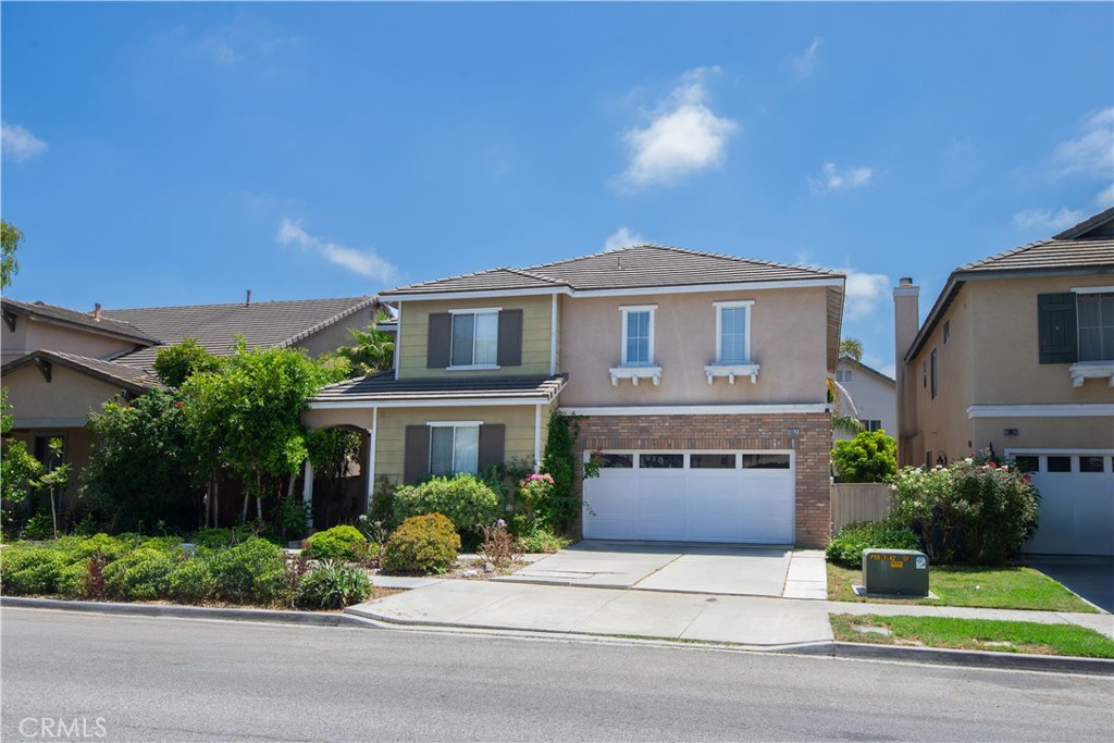1652 Tiesa Lane Oxnard, CA 93030 - Photo 6 of 9 a front view of a house with a yard and a garage