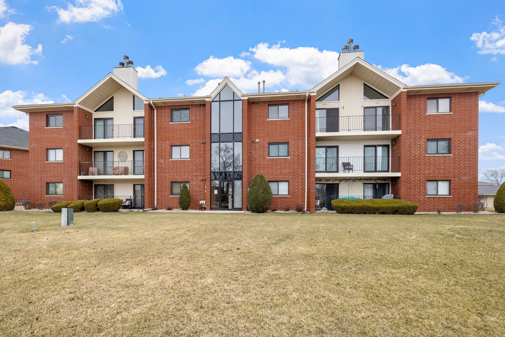 a view of a brick building next to a big yard