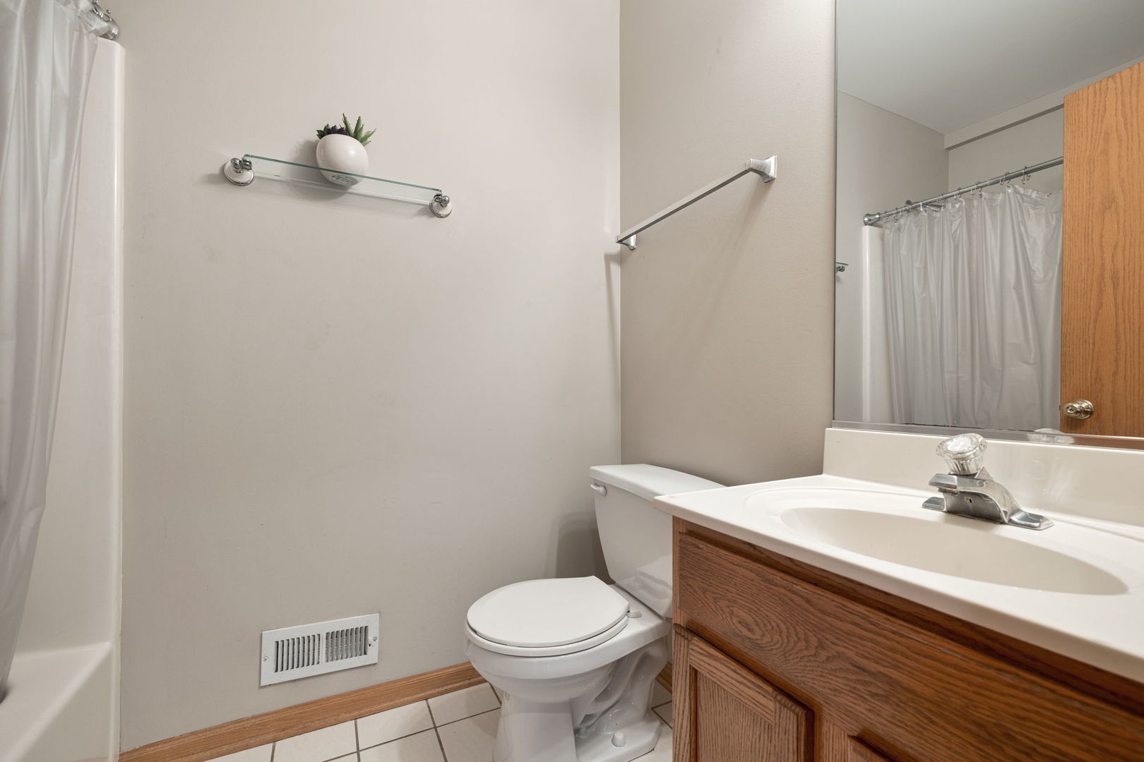 18112 Rita Road, Unit 3C Tinley Park, IL 60477 - Photo 15 of 18 a bathroom with a sink a toilet and a mirror
