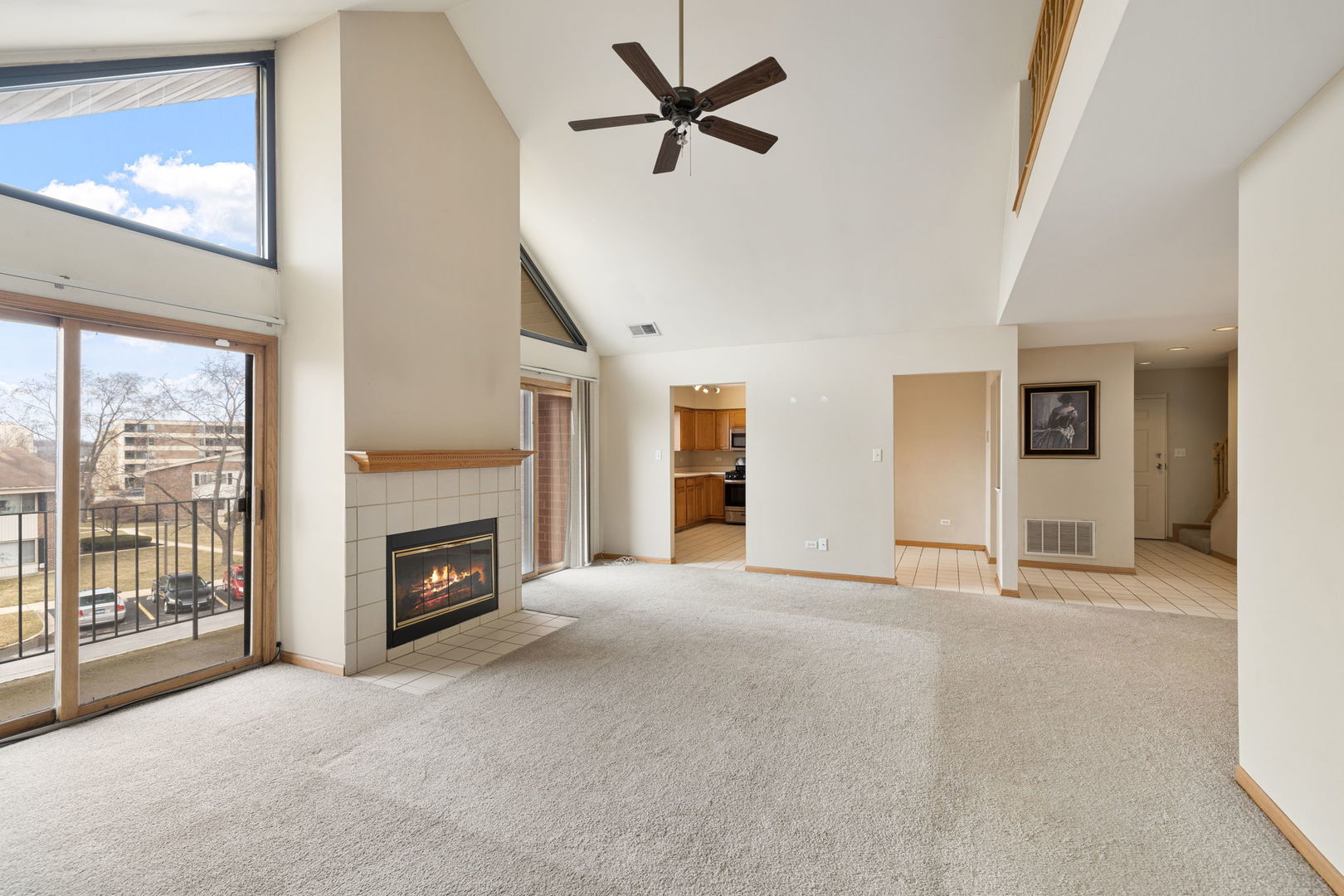 18112 Rita Road, Unit 3C Tinley Park, IL 60477 - Photo 2 of 18 a view of a livingroom with a fireplace and a chandelier fan