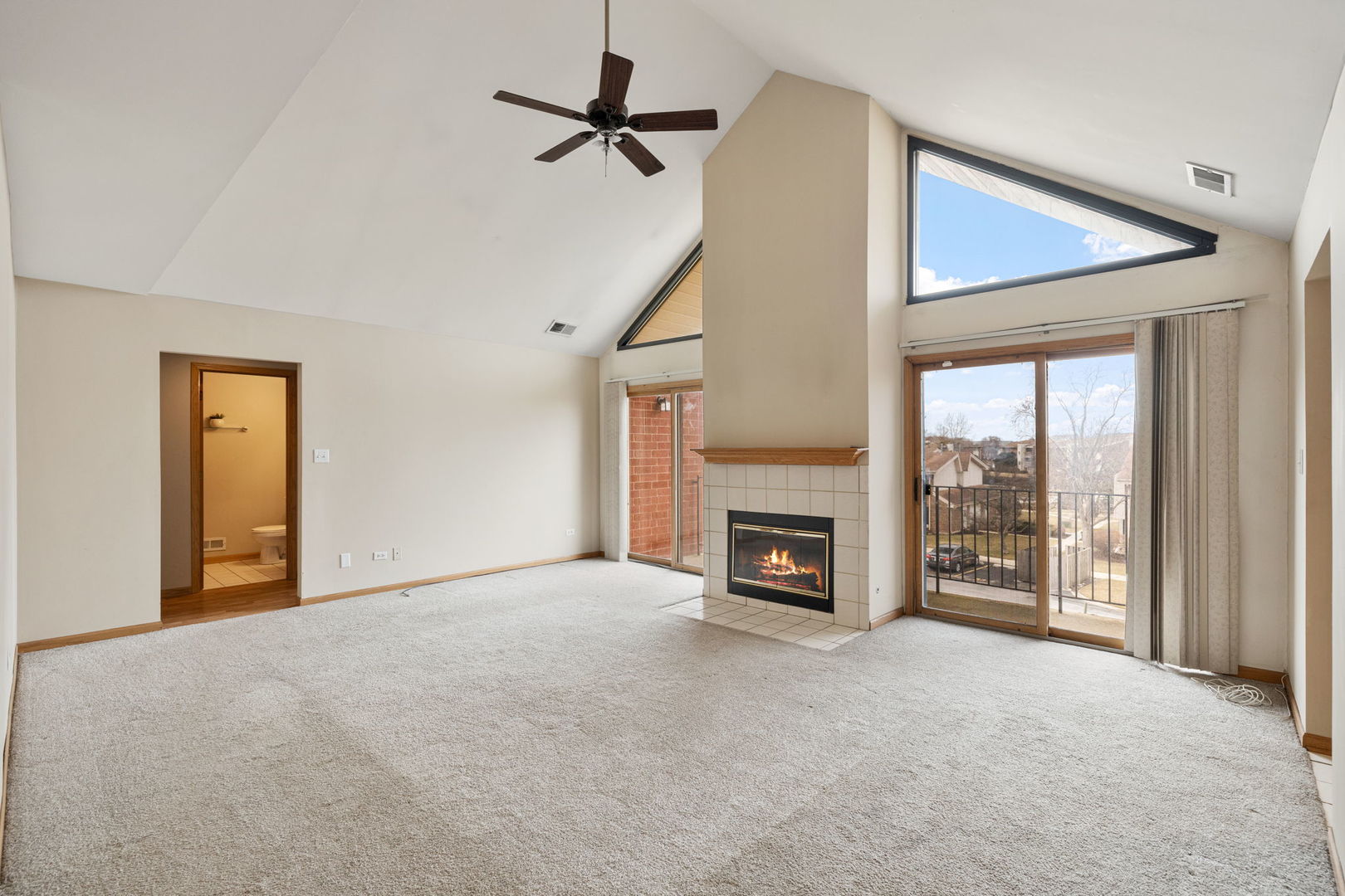 18112 Rita Road, Unit 3C Tinley Park, IL 60477 - Photo 10 of 18 a view of an empty room with a fireplace and a window