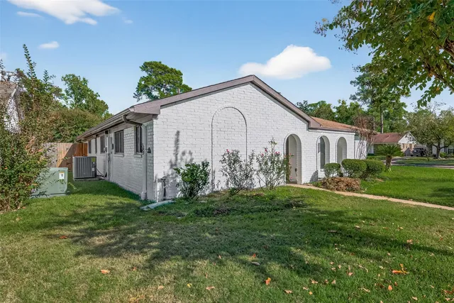 a front view of house with a garden