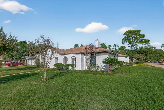 a view of a house with a yard and a garden