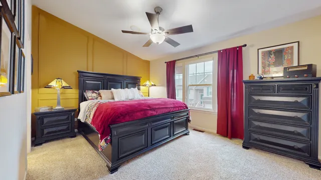 a spacious bedroom with a bed and a chandelier