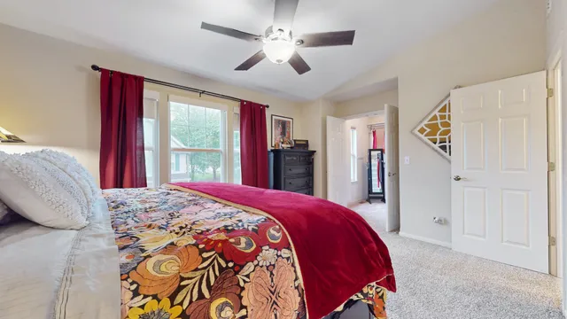 a bed room with a bed and a large window