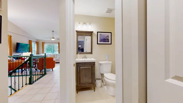 a bathroom with a toilet a sink and a mirror
