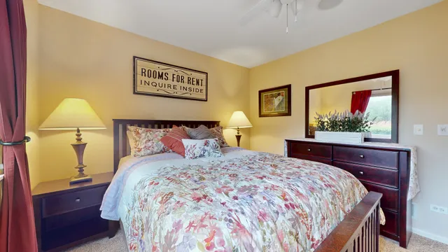 a bedroom with a bed and a dresser