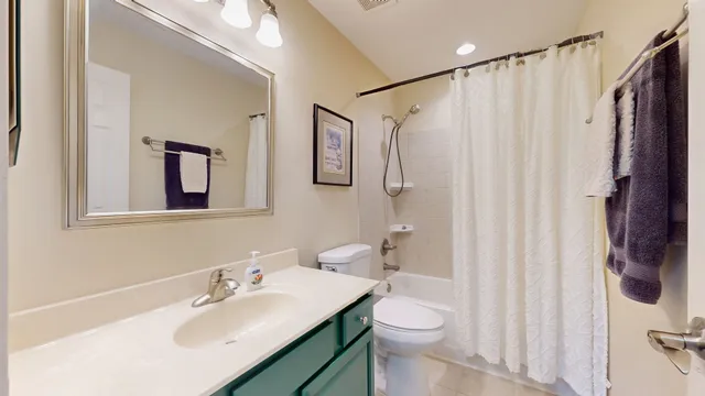 a bathroom with a sink vanity mirror and toilet