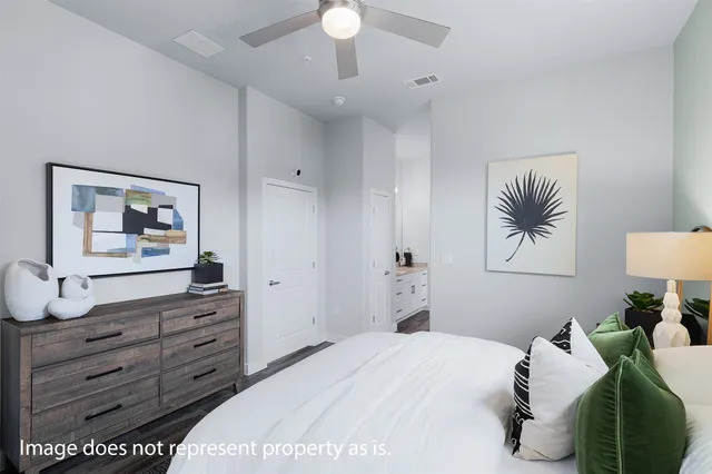 a bedroom with a bed and a dresser