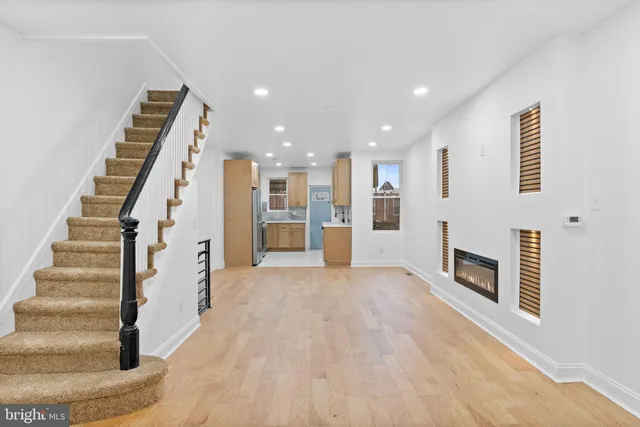 a view of a livingroom with an empty space and fireplace
