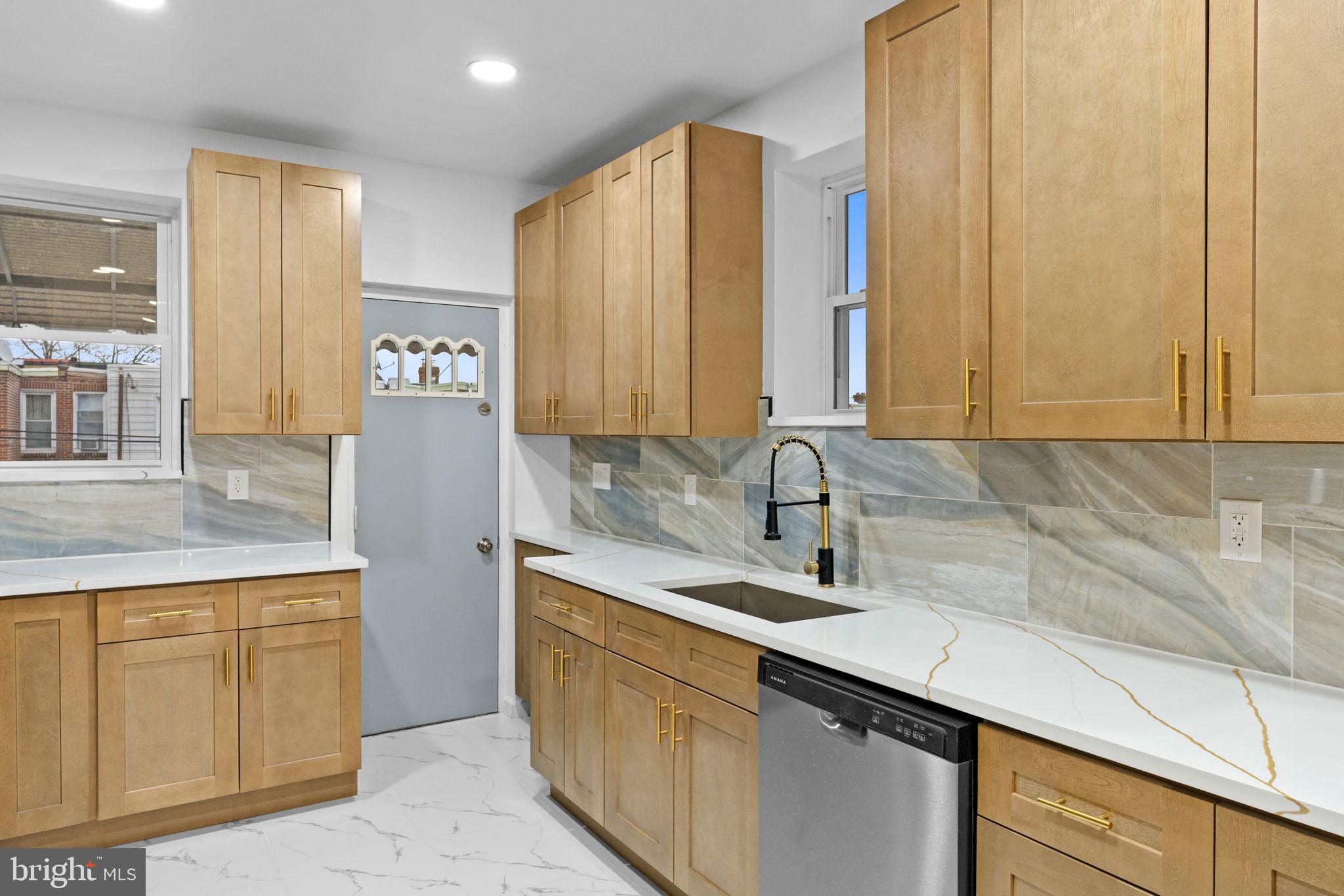 7331 East Walnut Lane Philadelphia, PA 19138 - Photo 14 of 49 a kitchen with stainless steel appliances granite countertop a sink and a cabinets