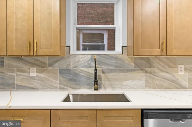 a kitchen with a sink and a window