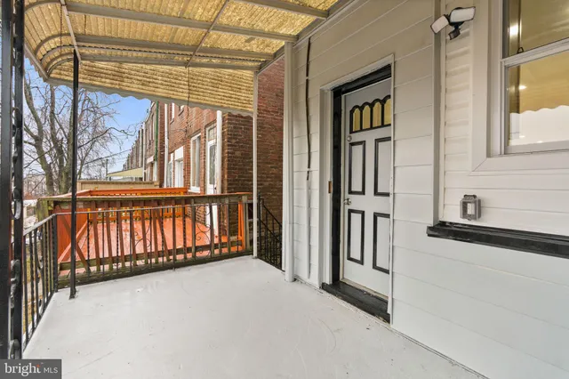 a view of a house with a wooden fence