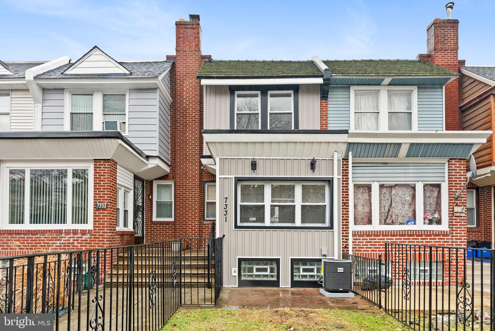 7331 East Walnut Lane Philadelphia, PA 19138 - Photo 2 of 49 a front view of a house with a yard