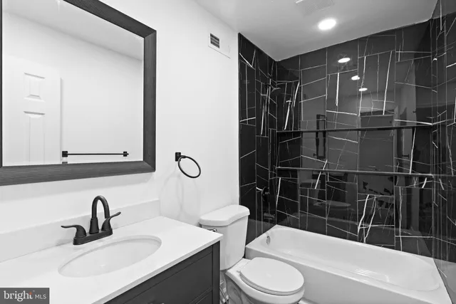 a bathroom with a toilet and shower