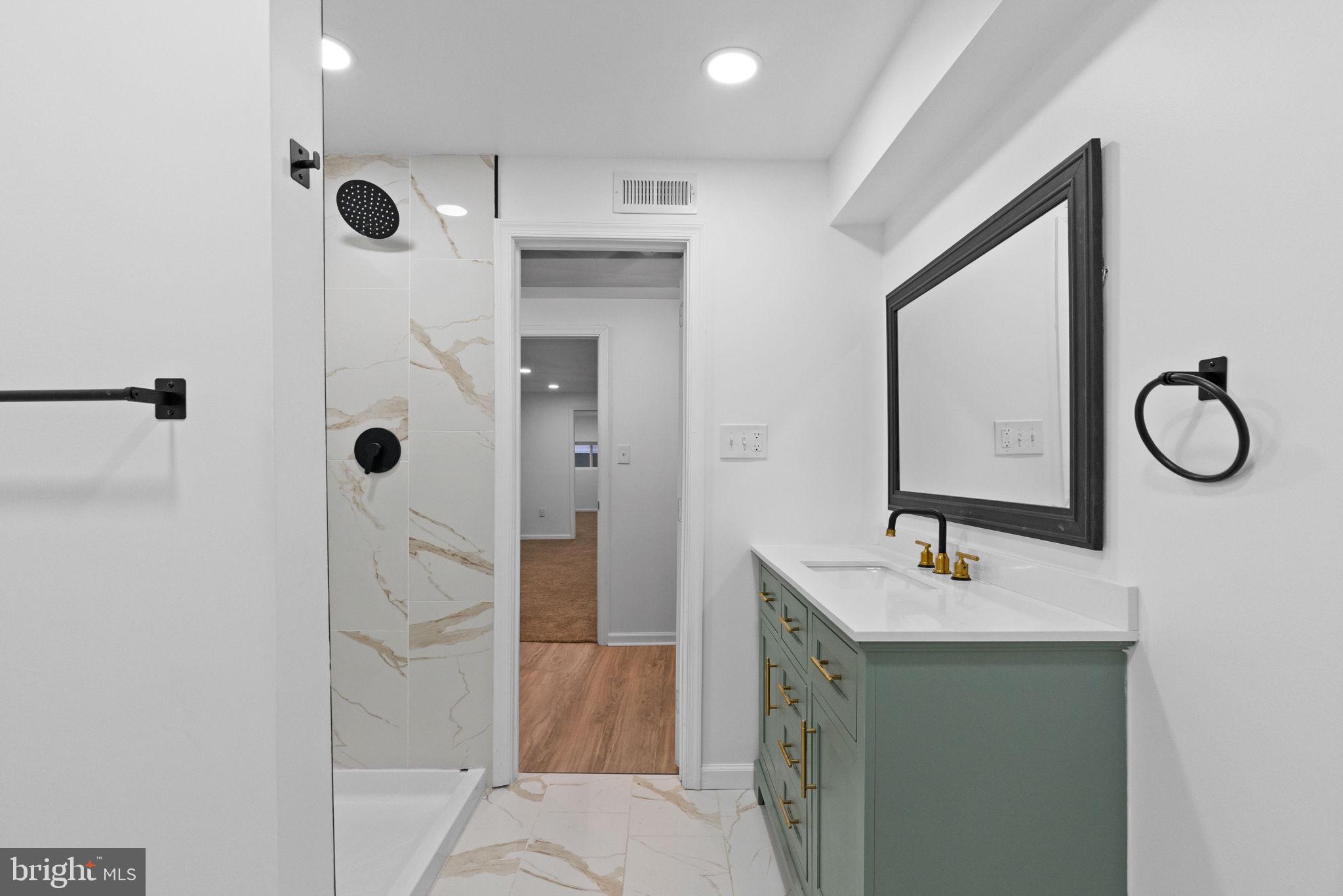 7331 East Walnut Lane Philadelphia, PA 19138 - Photo 48 of 49 a bathroom with a shower sink vanity and mirror