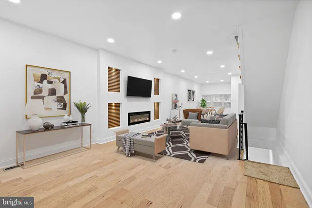 a living room with furniture a fireplace and a flat screen tv
