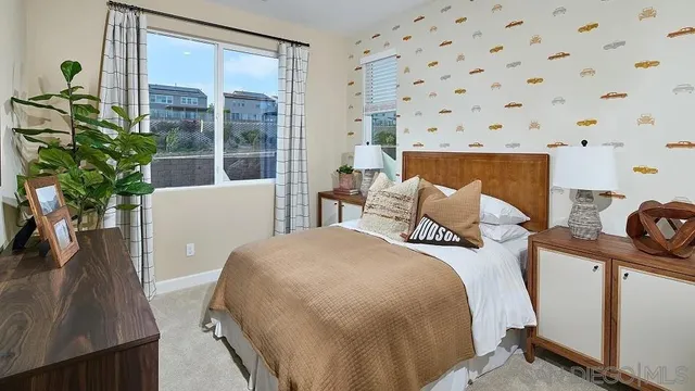 a bedroom with a bed and a large window
