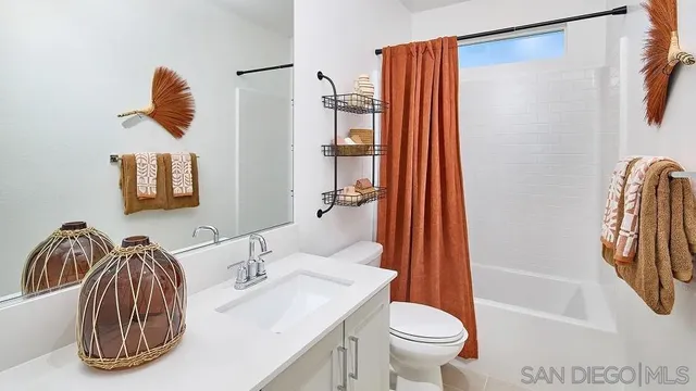 a bathroom with a sink a toilet and shower curtain