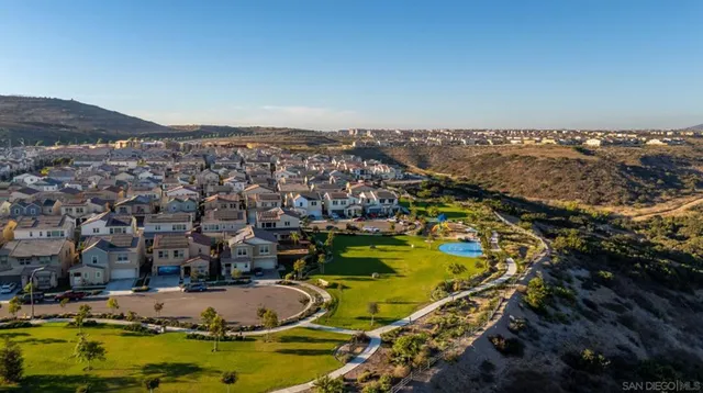 an aerial view of residential houses with outdoor space