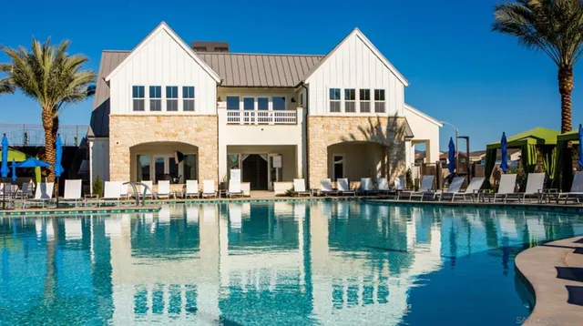 a front view of a house with swimming pool having outdoor seating