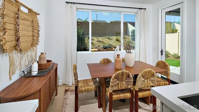 a view of a dining room with furniture window and outside view