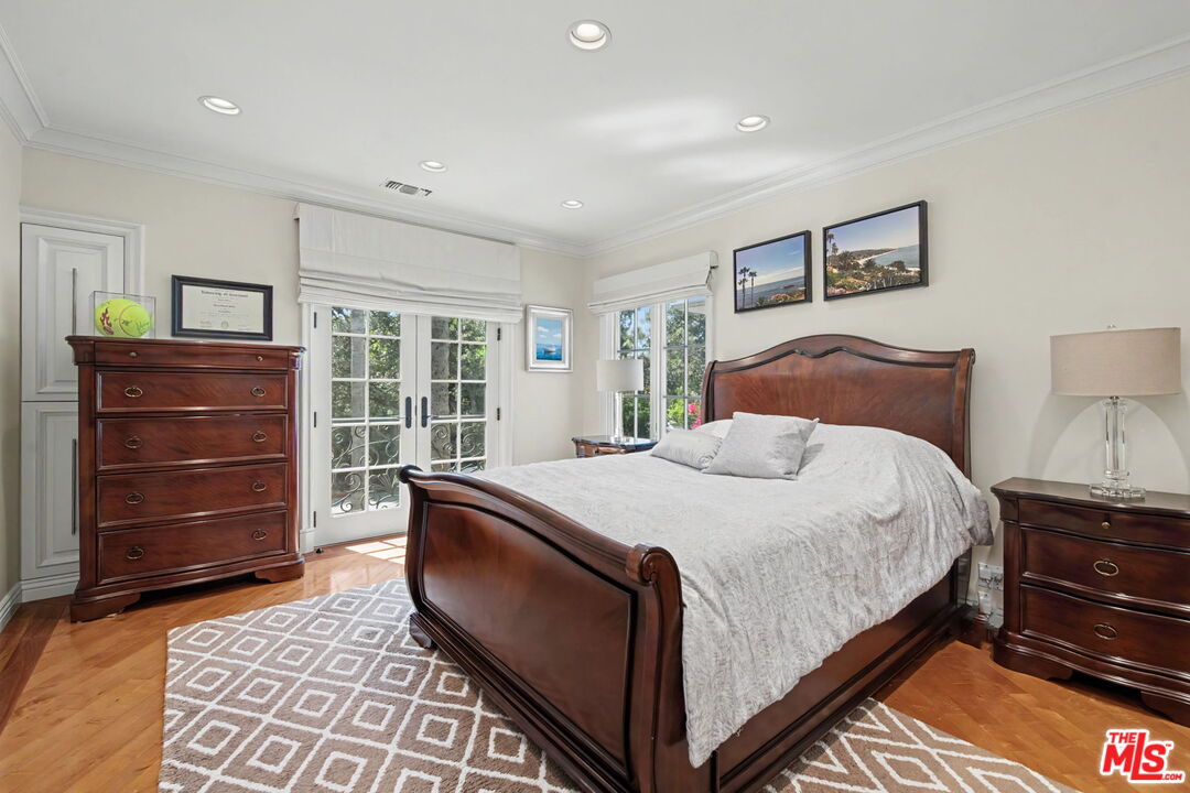 204 Foothill Road Beverly Hills, CA 90210 - Photo 21 of 38 a bedroom with a bed and a dresser
