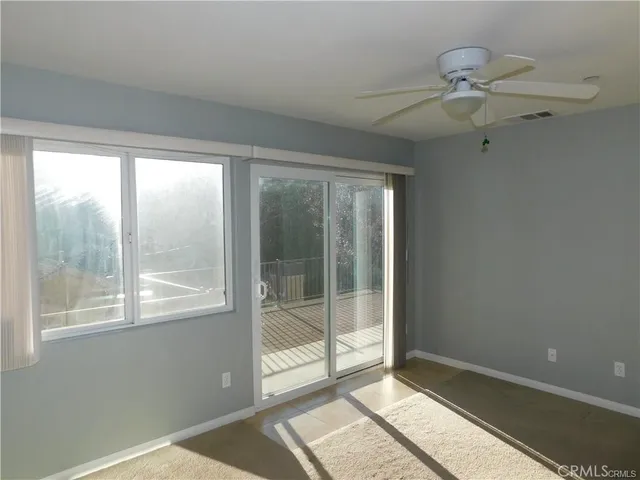 a view of empty room with ceiling fan
