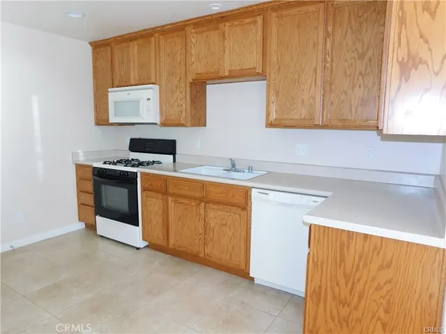 a kitchen with a stove sink and cabinets