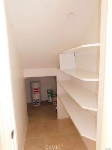 a kitchen with a sink a toilet and a mirror