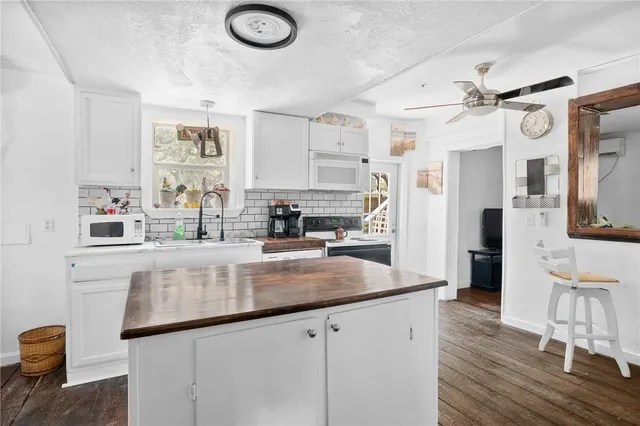 a kitchen with stainless steel appliances granite countertop a sink and refrigerator