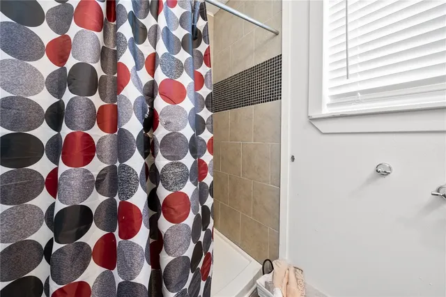 a bathroom with a bathtub and a shower curtain