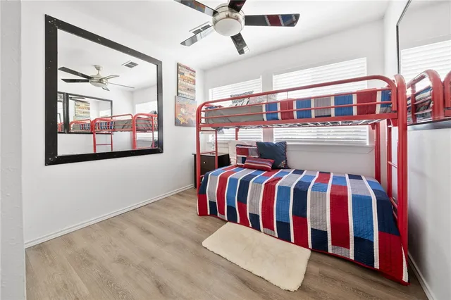 a bedroom with a bed and a painting on the wall