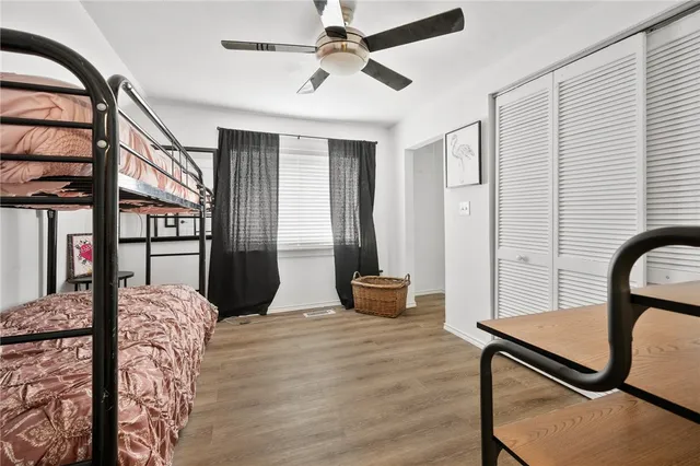 a bedroom with furniture and wooden floor