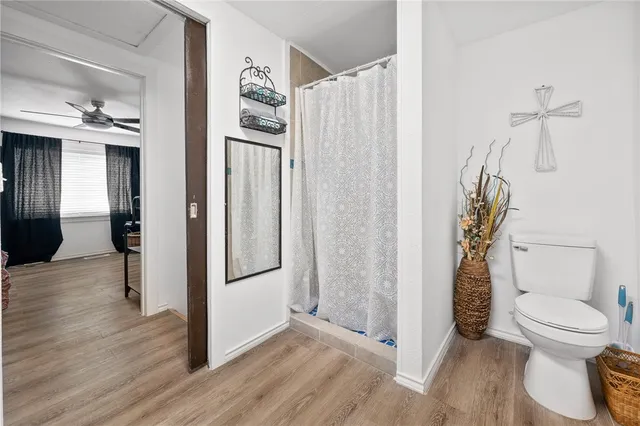 a bathroom with a toilet and a shower