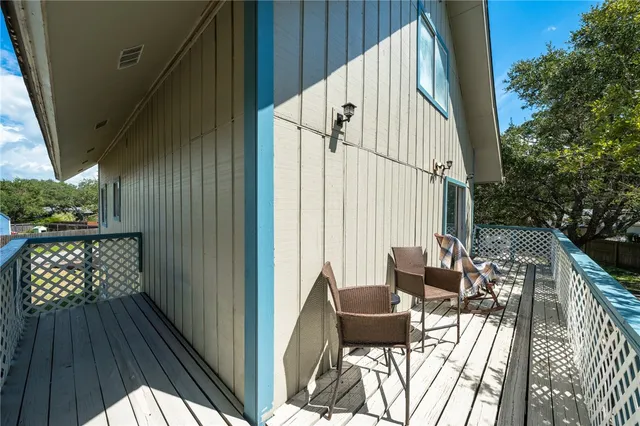 a view of balcony with chairs and wooden fence