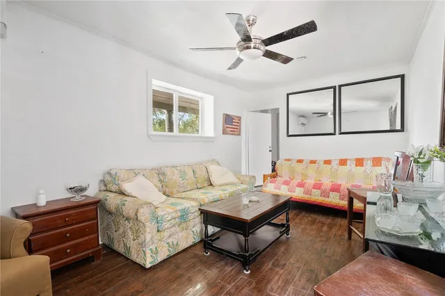 a living room with furniture and wooden floor