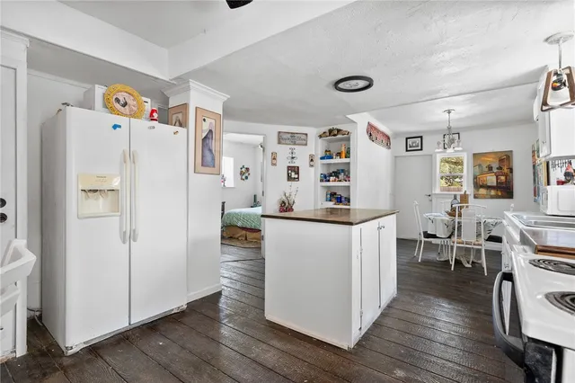 a white refrigerator freezer sitting inside of a kitchen