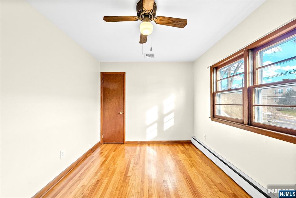 468 Broughton Avenue Bloomfield, NJ 07003 - Photo 12 of 15 a view of empty room with wooden floor and fan