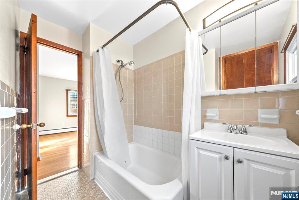 468 Broughton Avenue Bloomfield, NJ 07003 - Photo 13 of 15 a bathroom with a sink a toilet and shower