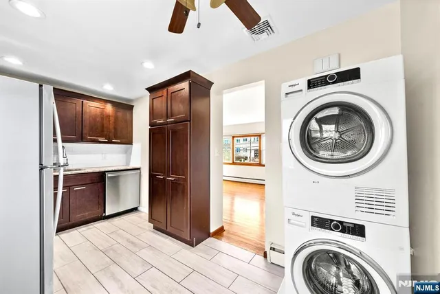 a view of a kitchen with a stove top oven cabinets and refrigerator