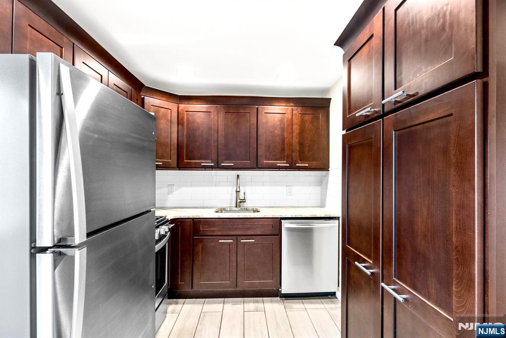 468 Broughton Avenue Bloomfield, NJ 07003 - Photo 8 of 15 a kitchen with stainless steel appliances granite countertop a refrigerator and a sink