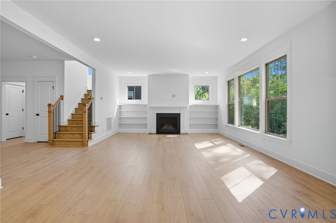 3731 Tuckmar Ridge Drive Moseley, VA 23120 - Photo 3 of 27 a view of a livingroom with wooden floor a fireplace and window
