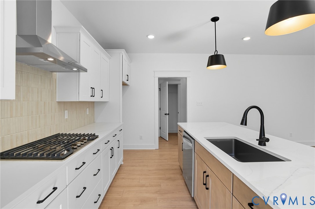3731 Tuckmar Ridge Drive Moseley, VA 23120 - Photo 10 of 27 a kitchen with stainless steel appliances a sink a stove and a wooden floors