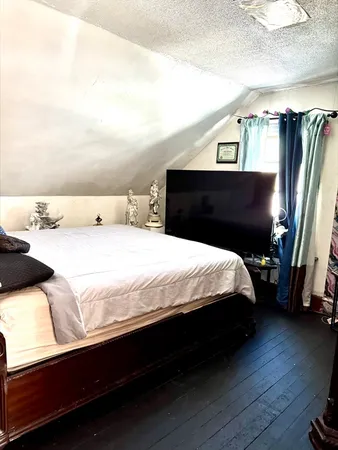 a bedroom with a bed and a night stand