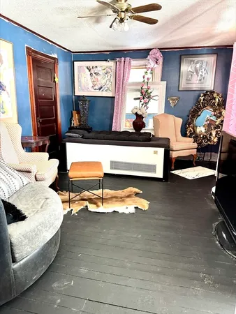 a living room with furniture pool table and a window