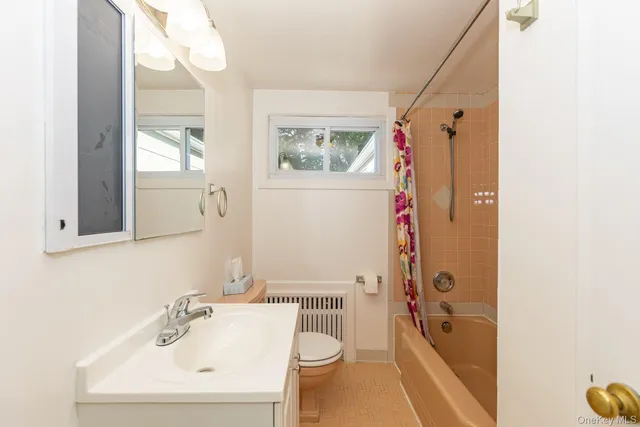 a bathroom with a sink mirror toilet and shower