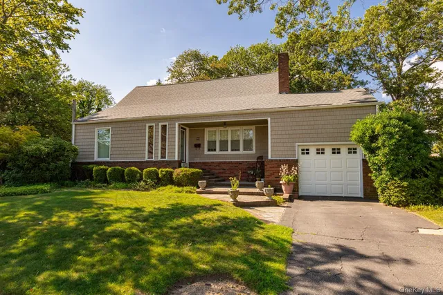 a view of a house with a yard patio and fire pit