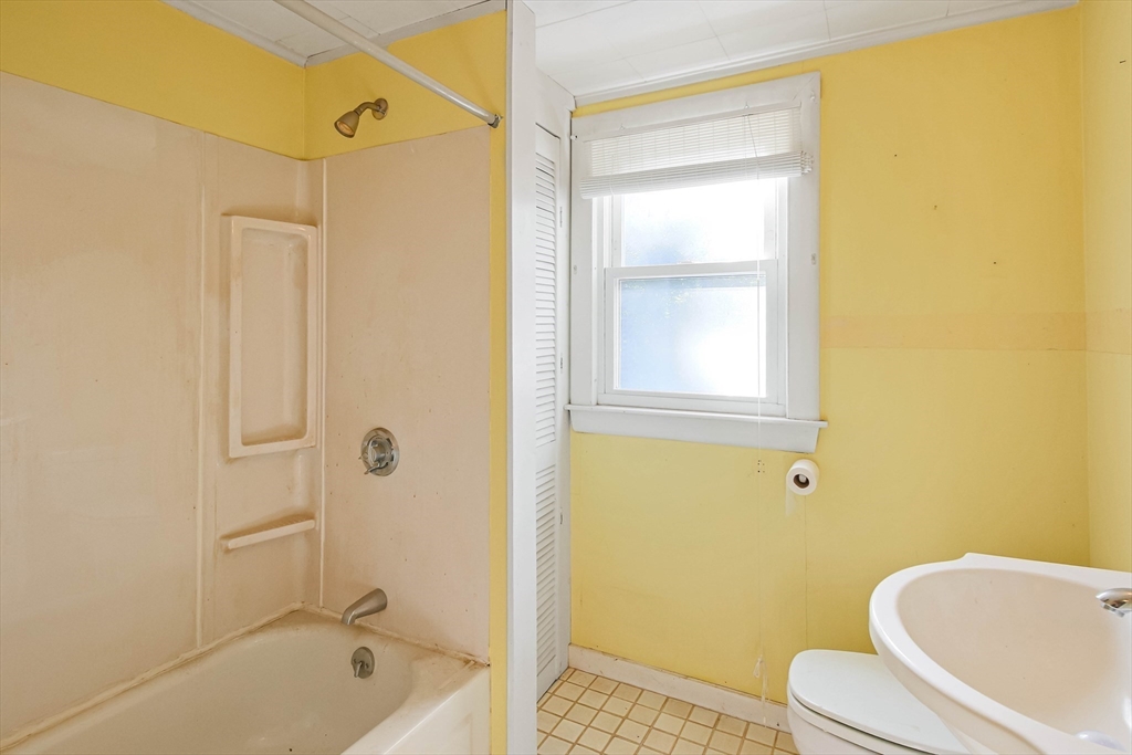 400 River Road Hudson, MA 01749 - Photo 17 of 24 a bathroom with a tub shower sink and a toilet